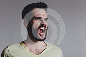 Young bearded man showing negative emotion