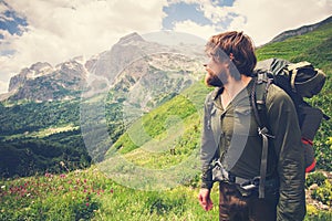 Young Bearded Man Traveler with backpack mountaineering