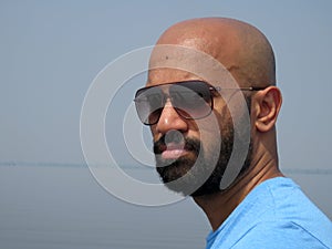 Young bearded serious man unaware that he is being photographed