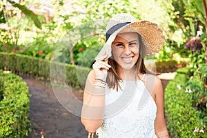 Young beatiful woman smiling happy and cheerful at green park on a sunny day of summer