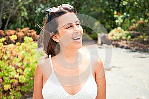 Young beatiful woman smiling happy and cheerful at green park on a sunny day of summer