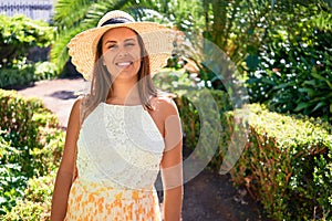 Young beatiful woman smiling happy and cheerful at green park on a sunny day of summer