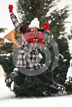 Young beauitiful woman outdoor in winter jumping