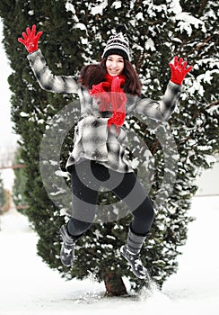 Young beauitiful woman outdoor in winter jumping