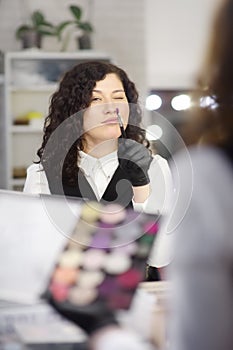 Young beautician having fun during work in a beauty salon