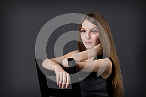 Young beautifu girl sitting on a Chair