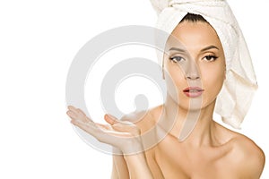 Young beautiful advertizing woman with towel on her head