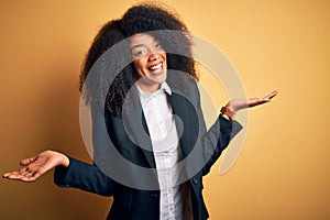 Young beautiful african american business woman with afro hair wearing elegant jacket clueless and confused expression with arms