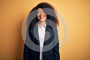 Young beautiful african american business woman with afro hair wearing elegant jacket with a happy and cool smile on face