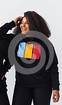Young beautiful african american girl with an afro hairstyle. Portrait on white background. Woman looking aside