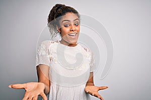 Young beautiful african american girl wearing casual t-shirt standing over white background smiling cheerful with open arms as