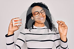 Young beautiful african american woman with curly hair smiling happy and confident