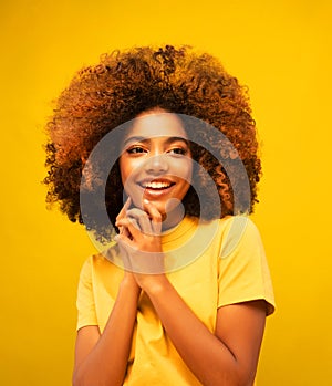 Young beautiful african american woman face close up teeth smile happy positive emotion.