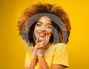 Young beautiful african american woman face close up teeth smile happy positive emotion.