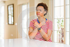 Young beautiful african american woman at home Pointing to both sides with fingers, different direction disagree