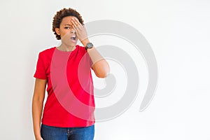 Young beautiful african american woman over white background Yawning tired covering half face, eye and mouth with hand
