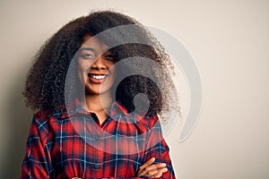 Young beautiful african american woman wearing casual shirt over isolated background happy face smiling with crossed arms looking