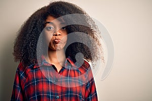 Young beautiful african american woman wearing casual shirt over isolated background puffing cheeks with funny face