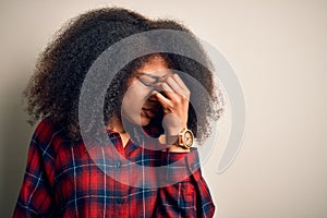 Young beautiful african american woman wearing casual shirt over isolated background tired rubbing nose and eyes feeling fatigue