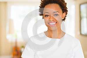 Young beautiful african american woman wearing casual white t-shirt with a happy and cool smile on face