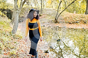 Young beautiful african woman walking in the autumn park