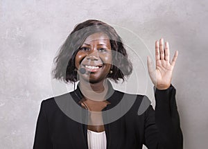 Young beautiful afro American woman coaching at seminar - happy and successful black businesswoman with headset speaking giving