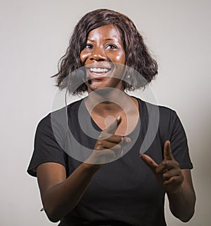 Young beautiful afro American woman coaching at seminar - happy and successful black businesswoman with headset speaking giving