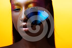 Young beautiful afro girl, vivid image with blue butterfly