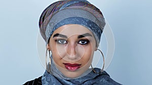 Young beautiful arabic woman smiles turning her head in disagreement on isolated white background