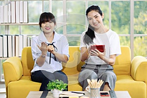 Young and beautiful Asain women sitting and demonstrat and communicate with hand sign, deaf language