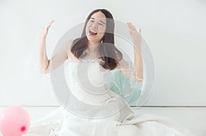 Young beautiful asian bride woman in white dress feeling Happy and funny with balloon