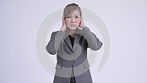 Young beautiful Asian businesswoman covering ears as three wise monkeys concept