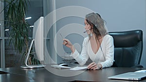 Young beautiful asian businesswoman with headset in office