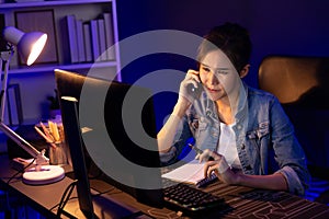 Young beautiful Asian creative woman calling on phone desk. Stratagem.