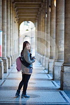 Young beautiful asian female traveler standing on the street in