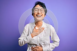 Young beautiful asian girl wearing casual shirt and glasses standing over purple background smiling and laughing hard out loud