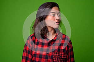 Young beautiful Asian hipster woman wearing red checkered shirt