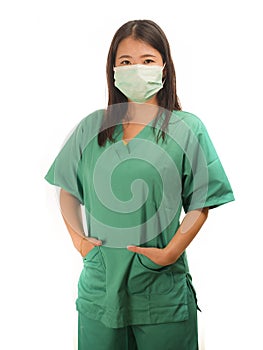Young beautiful Asian Korean medicine doctor woman or hospital nurse in scrubs using protective medical face mask in prevention