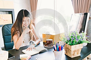 Young and beautiful Asian small business owner work at home office, organizing purchase order. Online marketing packaging delivery