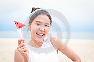 Young beautiful Asian smiling happy woman travels to the sea on vacation.