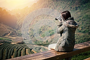 Young beautiful Asian tourist carry a digital camera