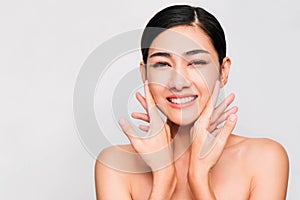 Young beautiful asian woman with clean and bright skin, Cosmetic Beauty Concept,hands touch on the cheek, smiling and friendly