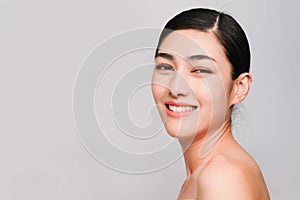 Young beautiful asian woman with clean, fresh and bright skin, Happiness and cheerful with positive emotional,isolated on gray