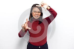 Making frame with hands and smile to the camera of Young beautiful asian women dress red shirt isolated on white background