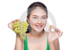 Young beautiful asian woman eating fresh grapes isolated on whit