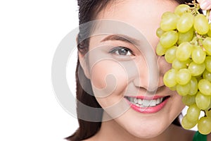 Young beautiful asian woman eating fresh grapes isolated on whit