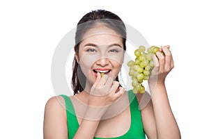 Young beautiful asian woman eating fresh grapes isolated on whit