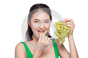 Young beautiful asian woman eating fresh grapes isolated on whit