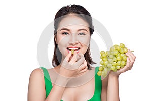 Young beautiful asian woman eating fresh grapes isolated on whit