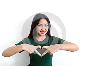 Young beautiful asian woman hands gesture in heart shape. Smile face asian girl wear green shirt. woman valentine day concept